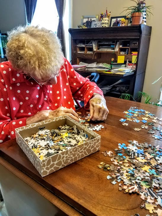Mom doing a puzzle